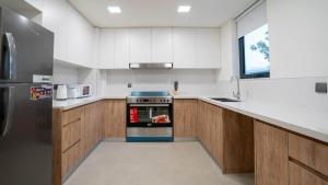 a kitchen with white counters and a stove top oven at 6br Family Heaven Playground in Abu Dhabi