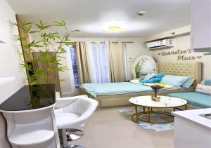 a living room with a bed and a couch at Cozy Studio with Balcony and Pool View in Lapu Lapu City