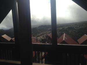a view of the mountains from a window at Chalés - Penhas da Saude in Penhas da Saúde