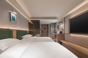 Letto o letti in una camera di China Youth Qiuguo Hotel - Wuhan Jiangxia Uni-Town Metro Branch
