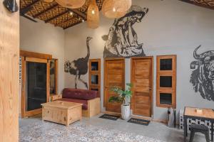 a living room with a couch and animals on the wall at Exotic Inn Semarang, by INNCA COLLECTION in Semarang +24 photos