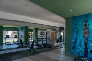a gym with a large painting on the wall at Sunset Cliffs Apartment by Leo Apartments Benidorm in Benidorm