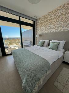 a bedroom with a large bed and a large window at Sunset Cliffs Apartment by Leo Apartments Benidorm in Benidorm +45 photos