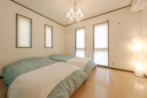 Postel nebo postele na pokoji v ubytování Hachioji Akatsuki Guest House 203