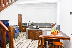 a kitchen with a table with a bowl of fruit on it at Villa serene galle in Galle