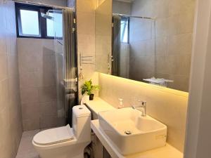a bathroom with a sink and a toilet and a mirror at The Shore by New Voyage in Kota Kinabalu +12 photos