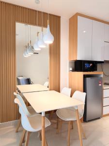 a kitchen and dining room with a table and chairs at The Shore by New Voyage in Kota Kinabalu