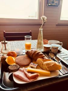 a plate of food with bread and cheese and toast at Hotel Restaurant Argos, Strasbourg Nord in Vendenheim