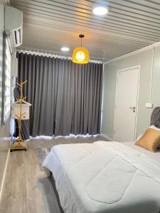 a bedroom with a large white bed and a window at VILLA CHENTA BACHOk KELANTAN in Bachok +22 photos