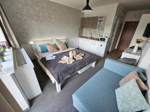 a room with a bed with a person laying on it at Apartmán Filip wellness,krytý bazén in Tatranska Strba