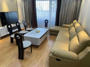a living room with a couch and a table at Comfy classic apartment in Central UB in Ulaanbaatar +3 photos