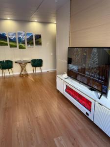 a living room with a large flat screen tv at Comfy classic apartment in Central UB in Ulaanbaatar