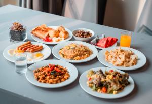 a table full of plates of food on a table at SureStay by Best Western Iconic Ari-Jatujak in Bangkok