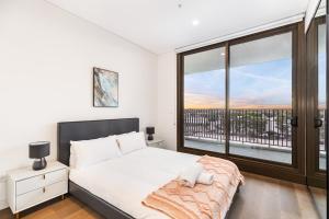Katil atau katil-katil dalam bilik di 3BR apartment close to Accor Stadium +14 gambar