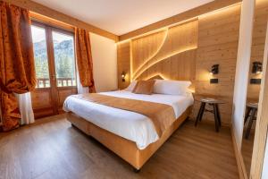 Łóżko lub łóżka w pokoju w obiekcie Hotel Petit Tournalin