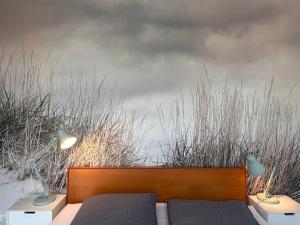 a bedroom with a bed and two lamps and grass at Ankerplatz-1-Kiel Parkplatz in Kiel