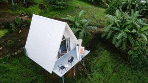 an aerial view of a tiny house in the grass at A-Frame in Ban Mae Na