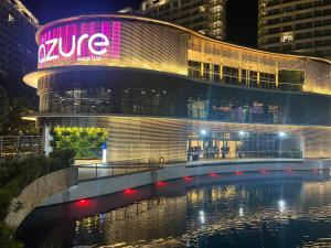 a building with a sign on the side of it at The Bahamas & Maldives Suites at Azure Residences near Manila Airport in Manila