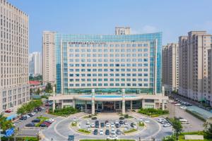 a large building in the middle of a city at Bliss International Hotel in Weihai