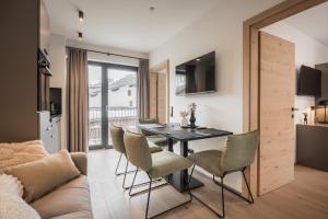 a kitchen and dining room with a table and chairs at Gipfelglueck Family in Kirchberg in Tirol +7 photos