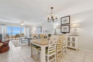 a dining room and living room with a table and chairs at Short Walk to the Beach Condo in Fernandina Beach