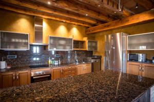 a large kitchen with wooden cabinets and stainless steel appliances at La Cajola in Lladurs