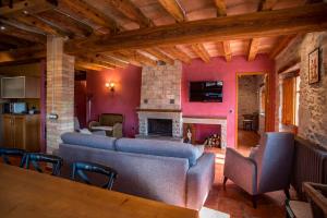 a living room with couches and a fireplace at La Cajola in Lladurs