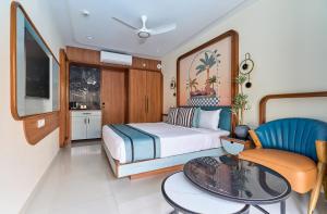 a bedroom with a bed and a table and a chair at Estrela Do Mar Beach Resort - A Beach Property in Calangute