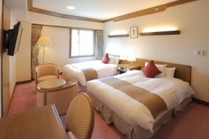 Postel nebo postele na pokoji v ubytování Kurashiki Kokusai Hotel