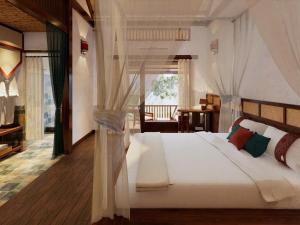 a bedroom with a large white bed in a room at Pù Luông Ecolodge in Pu Luong