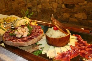 a tray of food with different types of food at Hotel Spartivento in Chia