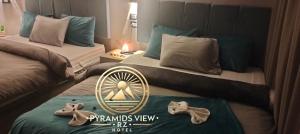 Krevet ili kreveti u jedinici u objektu Pyramids View R Z Hotel
