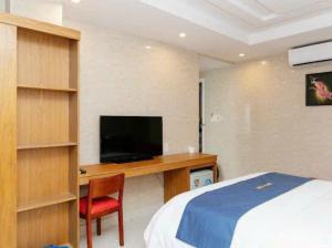 a bedroom with a bed and a desk with a television at Thái An Hotel Hồ Chí Minh in Ho Chi Minh City +27 photos