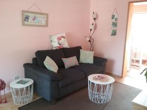 a living room with a couch and two tables at Ferienhaus "Martha" in Berndshof +25 photos