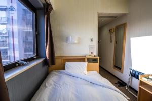 Ramada Encore by Wyndham Amagasaki客房内的一张或多张床位