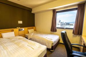 Ramada Encore by Wyndham Amagasaki客房内的一张或多张床位
