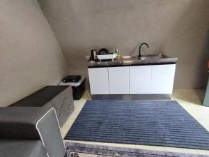 a kitchen with a sink and a counter top at Dome Glamping Lojing Highlands in Ladang Pangoi