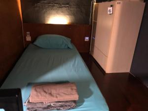 a bed in a small room with two towels on it at OA ThE FACTORY AT BUKIT BINTANG in Kuala Lumpur