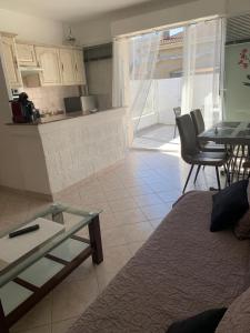a living room with a couch and a table at Sables de biguglia cordon lagunaire in Borgo