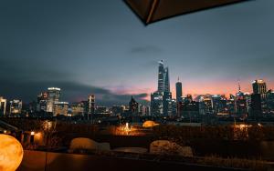 a view of a city skyline at night at Novotel Atlantis Shanghai - Enjoy our great-valued breakfast in our rooftop revolving restaurant with a stunning river view & utilize our FREE self-serviced laundry in Shanghai