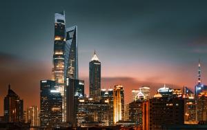 a city skyline at night with tall buildings at Novotel Atlantis Shanghai - Enjoy our great-valued breakfast in our rooftop revolving restaurant with a stunning river view & utilize our FREE self-serviced laundry in Shanghai