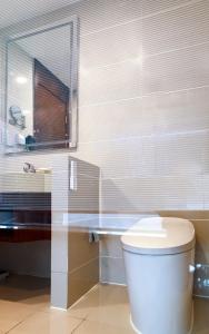 a bathroom with a white toilet and a sink at Novotel Atlantis Shanghai - Enjoy our great-valued breakfast in our rooftop revolving restaurant with a stunning river view & utilize our FREE self-serviced laundry in Shanghai