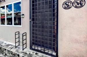 a large black door on the side of a building at Sun & Moon Homestay in Port Dickson