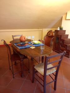 a dining room table with chairs and a pumpkin on it at la mansarda di Ele in Lucca