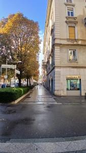 an empty street in a city with a building at The Corner Bergamo Elegant Apartments in Bergamo