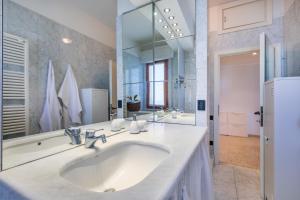 a bathroom with a sink and a large mirror at Italianway - Rossetti 3 in Marina di Cecina +37 photos