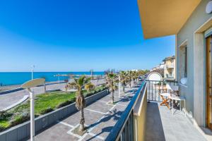 a balcony with a view of the beach at Italianway - Rossetti 3 in Marina di Cecina