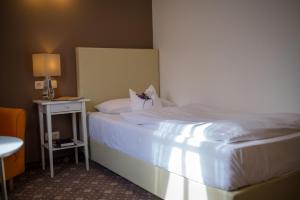 Postel nebo postele na pokoji v ubytování Hotel Leicht