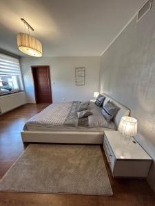 a bedroom with a large bed and a table at Apartmán Raková NO1 in Raková +13 photos