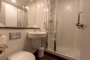 a bathroom with a shower and a toilet and a sink at Travelodge Barcelona Poblenou in Barcelona